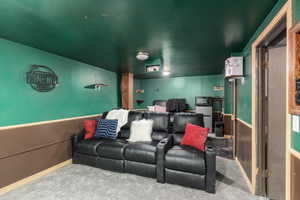 Cinema room with carpet and baseboards