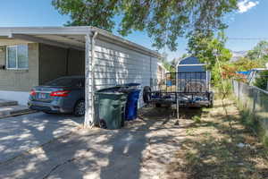 View of property exterior with a carport and RV Pad