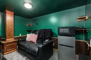Home theater with carpet flooring and decorative columns