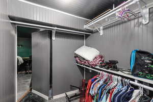 Walk in closet with carpet flooring