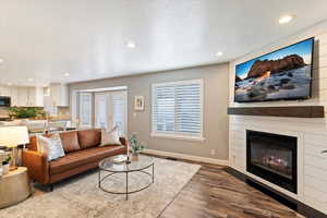 Living area featuring recessed lighting, wood finished floors, and a fireplace