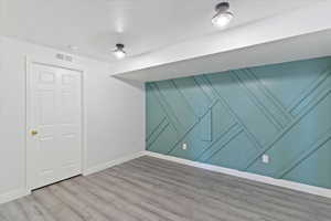 Empty room with baseboards and wood finished floors