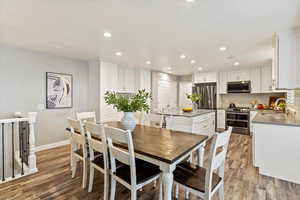 Dining space with light wood-style flooring and recessed lighting