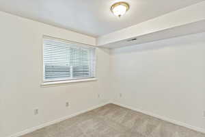 Spare room with carpet floors and baseboards