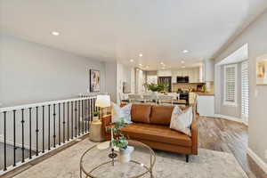 Living room with light wood-style floors and recessed lighting