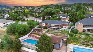Aerial perspective of suburban area with a pool area and a mountainous background