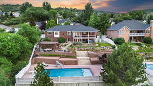 Back of property with stairway, a pergola, and a patio area