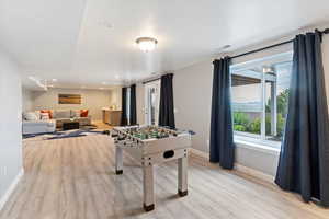 Game room with light wood finished floors and recessed lighting