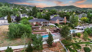 Aerial perspective of suburban area featuring a pool and mountains