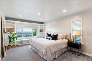 Carpeted bedroom with recessed lighting and a textured ceiling