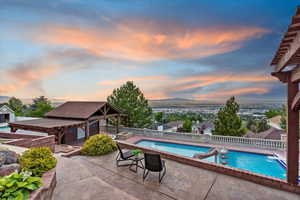 View of pool with a gazebo, a fenced backyard, a patio area, and a water slide