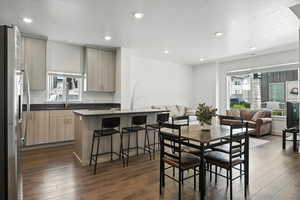Dining space with dark wood finished floors and recessed lighting