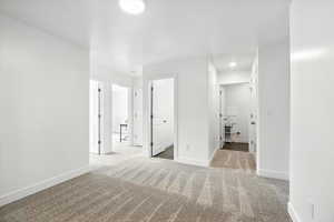 Carpeted spare room featuring baseboards and recessed lighting