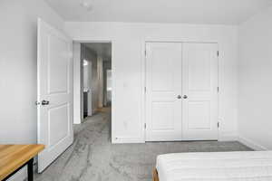 Bedroom with carpet and a closet