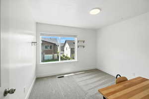 Unfurnished room featuring carpet flooring and baseboards