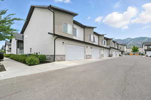 View of asphalt road featuring a mountain view and a residential view