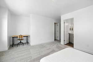 Bedroom with carpet floors and ensuite bathroom