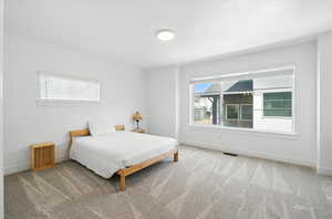 Carpeted bedroom with baseboards