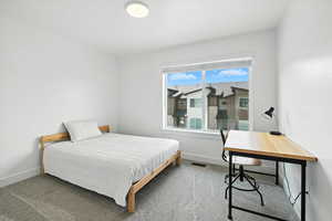Bedroom featuring carpet floors and an office area