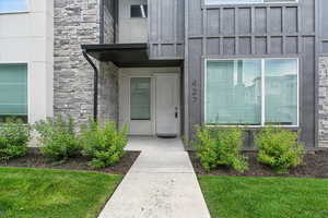 Entrance to property with stone siding and board and batten siding