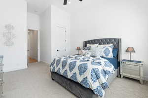Carpeted bedroom with baseboards and ceiling fan