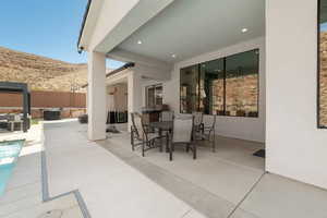 View of patio / terrace featuring a mountain view, outdoor dining space, and an outdoor hangout area