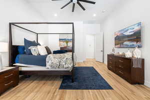 Bedroom featuring light wood-type flooring, vaulted ceiling, a ceiling fan, and recessed lighting