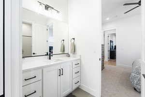 Ensuite bathroom with ceiling fan, vanity, and recessed lighting
