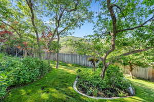 Fenced backyard featuring a mountain view