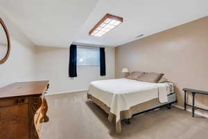Bedroom with light carpet and baseboards