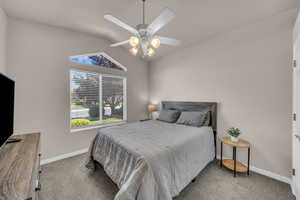 Bedroom with carpet floors, lofted ceiling, and ceiling fan