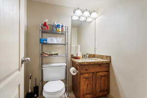 Half bath featuring vanity and toilet