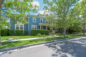 American foursquare style home featuring a front lawn