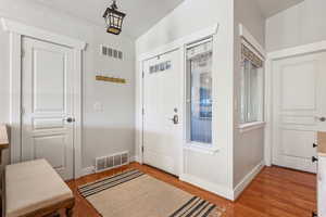 Entryway with light wood-style floors and baseboards