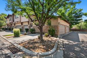 View of front of home with stucco siding, stone siding, and a residential view