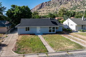 View of front of house featuring a mountain view and roof with shingles