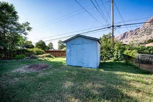 Fenced backyard with a storage shed