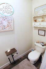 Bathroom with wood finished floors and baseboards
