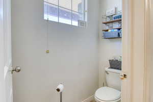 Bathroom with toilet and baseboards