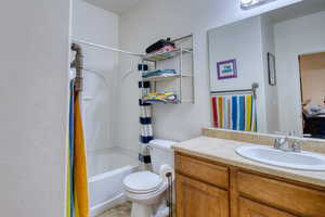 Bathroom featuring vanity and shower / bath combination with curtain
