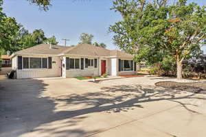 Single story home with concrete driveway and roof with shingles