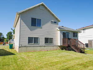 Back of house with a yard