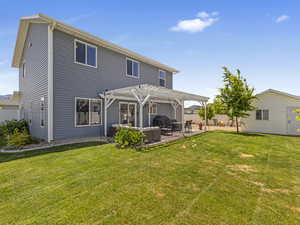 Back of house with a pergola and a patio, perfect for entertaining.