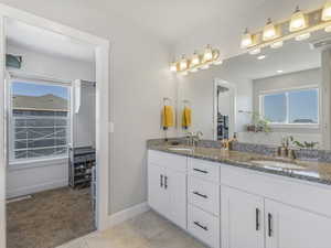 Primary bathroom with double vanity and large soaking tub.