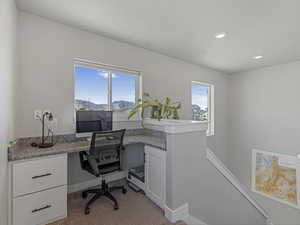 Office area with built in study area, healthy amount of natural light, carpet flooring, and recessed lighting.