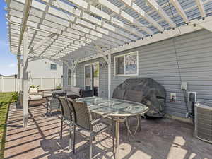 View of patio with an outdoor hangout area, a pergola, a grill, and outdoor dining area