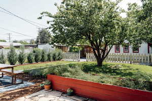 Fenced front yard with a garden
