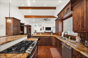 Kitchen with stainless steel appliances, dark wood-style floors, light stone counters, recessed lighting, and glass insert cabinets
