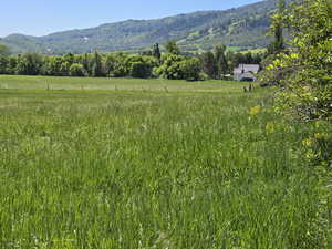 View of mountain backdrop with rural landscape