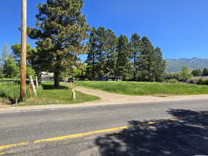 View of asphalt street featuring a mountain view